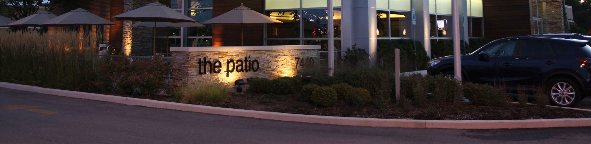 The Patio restaurant building with a light up sign.