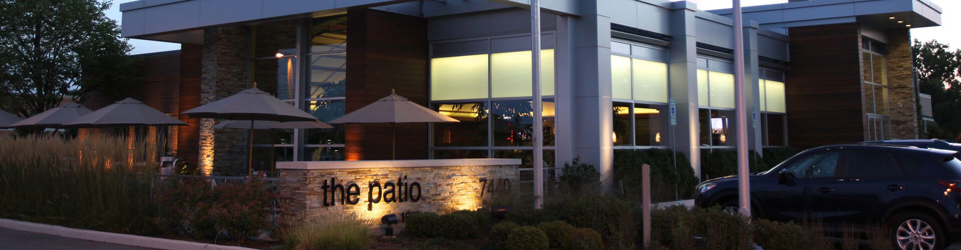The Patio restaurant building with a light up sign.